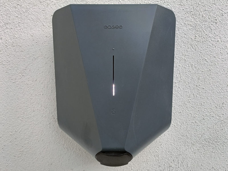 Grey EV charge point on white wall